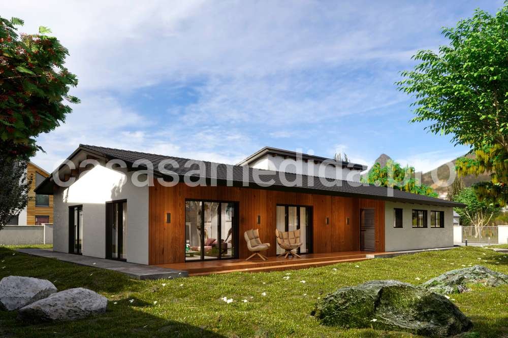 Casa prefabricada de una planta con ventanales grandes y dos tipos de acabado en la fachada madera y revoco. Casa de estilo Escandinavo con acabados modernos.