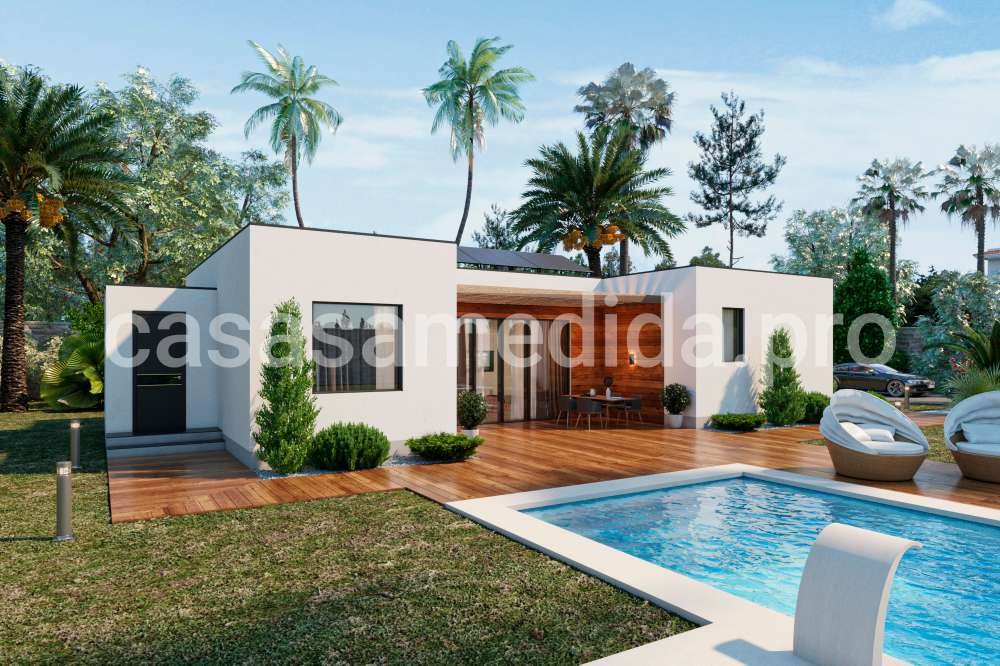 Casa prefabricada moderna de diseño cubico y con fachada blanca, amplios ventanales y estilo contemporáneo.