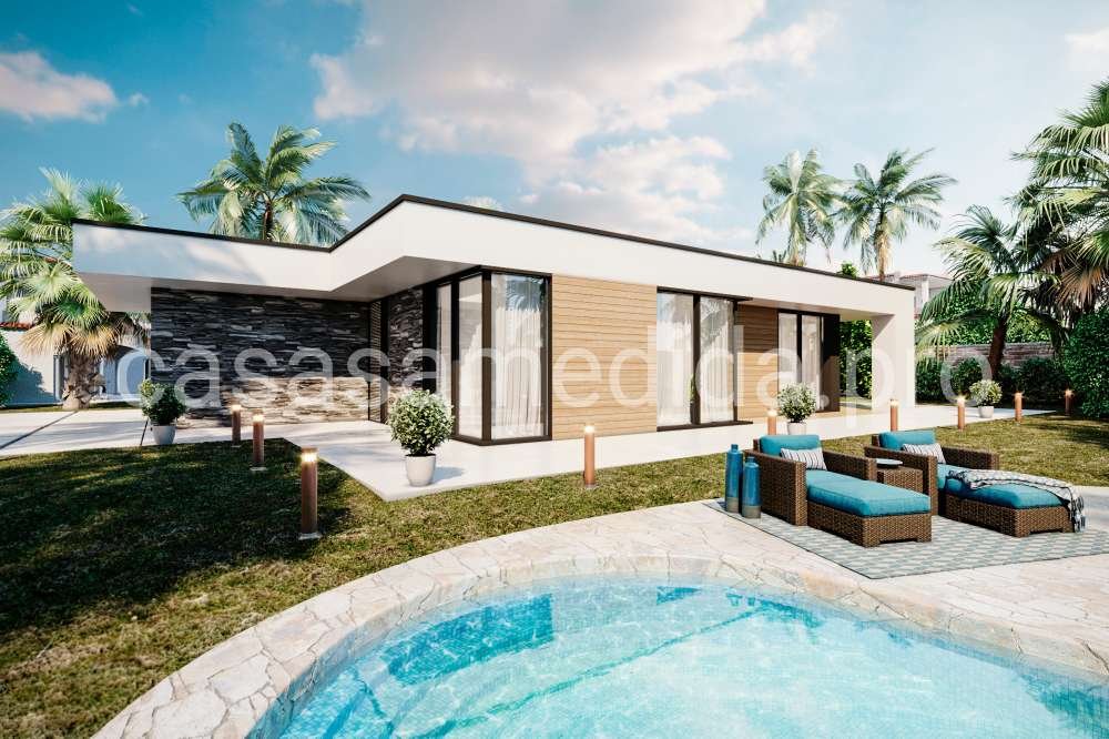 Casa prefabricada de diseño cúbico con amplios ventanales y acabados tradicionales. Los materiales utilizados en su construcción son de alta calidad y eficiencia energética, proporcionando un ambiente acogedor y moderno."